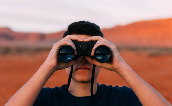 Looking binoculars.